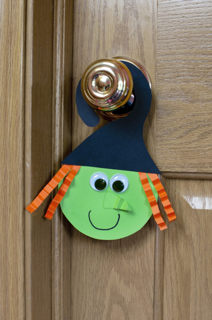 witch paper Halloween Crafts hanging on the door 