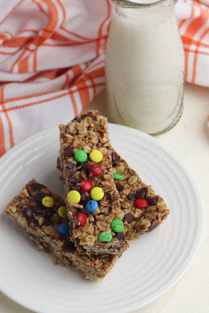 Easy homemade granola bars  on a plate and a glass of milk