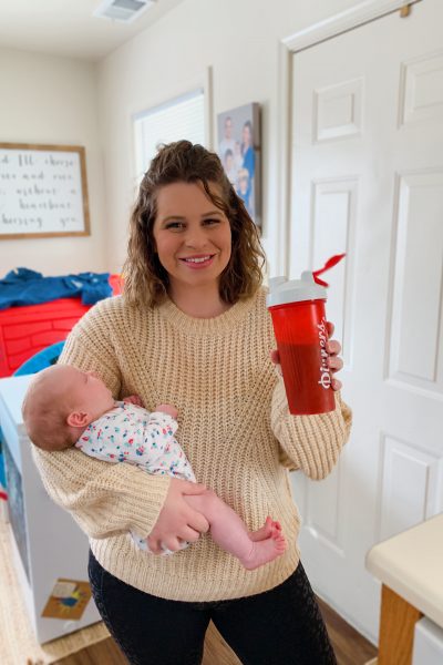 woman carrying her baby and holding a Kid friendly smoothies 