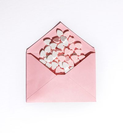 Fun ways to celebrate Valentine’s Day at home pink envelop with hearts 